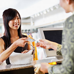 Image: Woman making purchase © Tim Pannell/Corbis